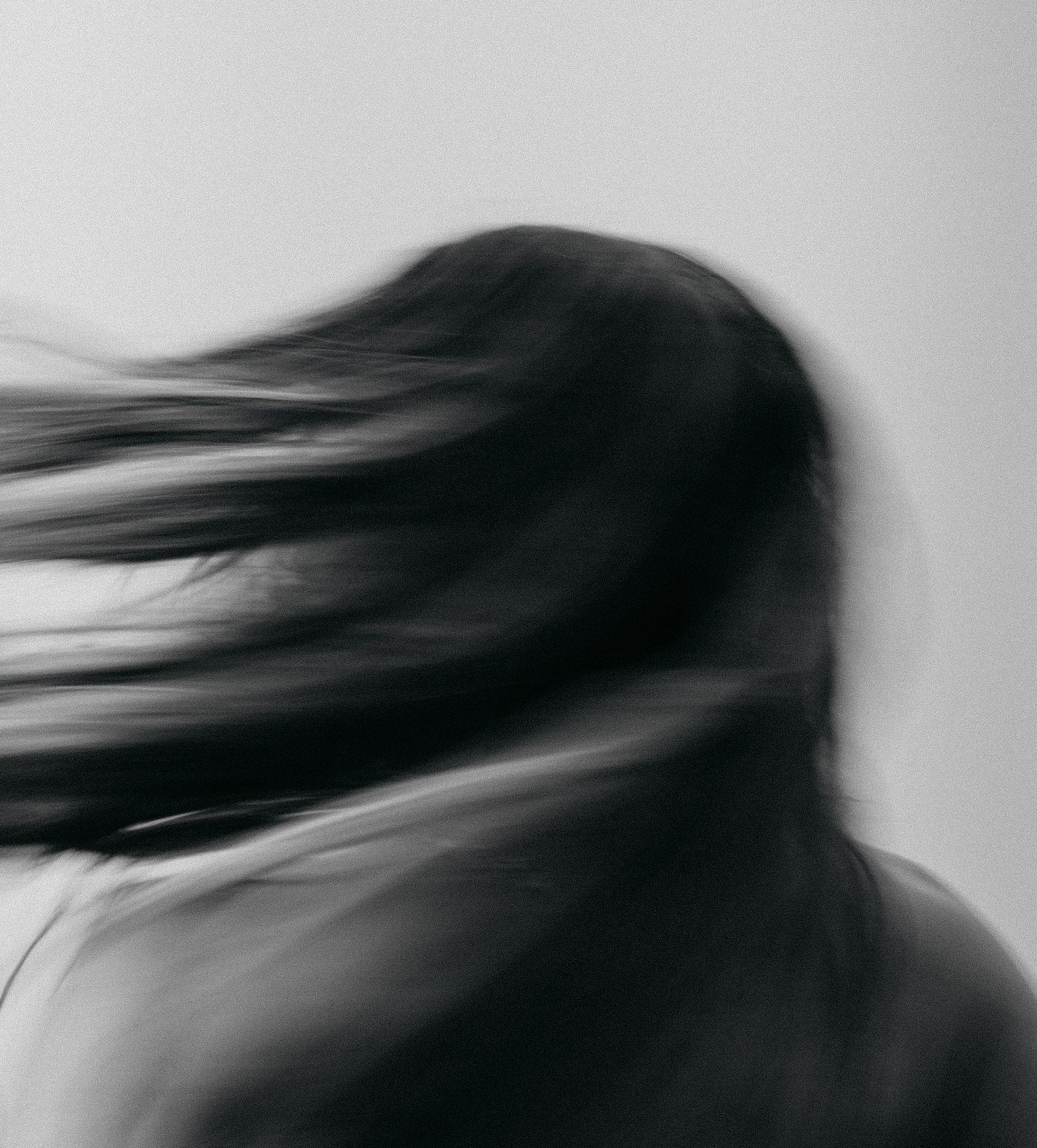Black and white long-exposure portrait with hair in motion blur