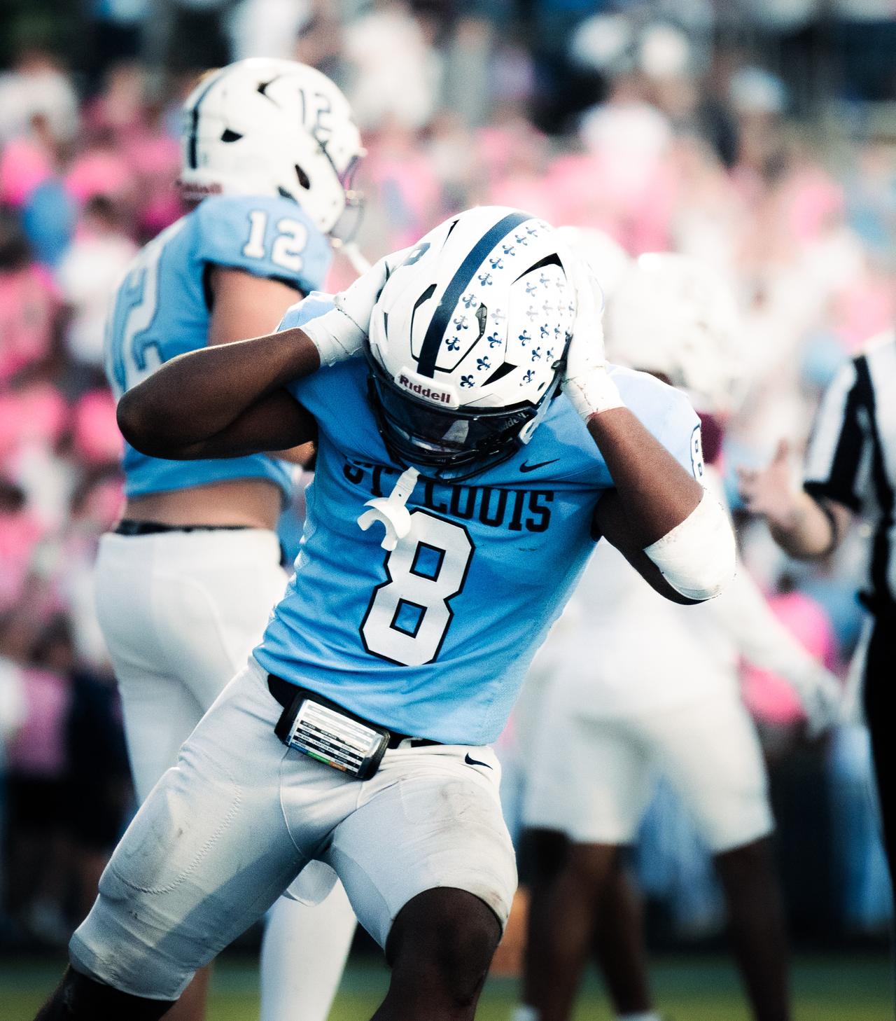 St. Louis player number 8 in light blue with both hands on his helmet
